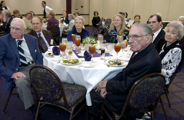 A group of attendees at a dinner event.
