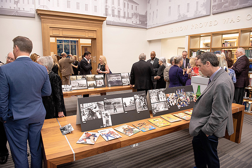 Guests mingled around a display of TCU historic photos.
