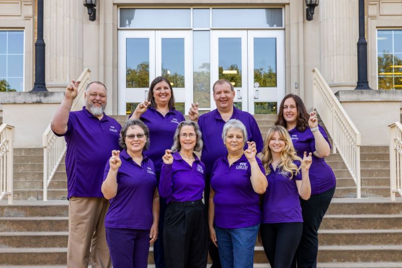 Reference librarians in front of TCU Mary Couts Burnett Library.